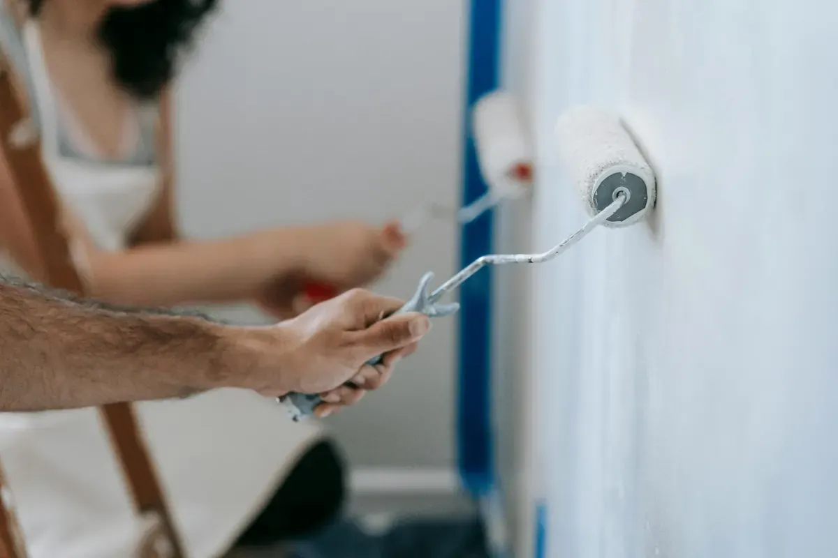 Happy couple painting a wall during a home improvement project for the Bunnings case study