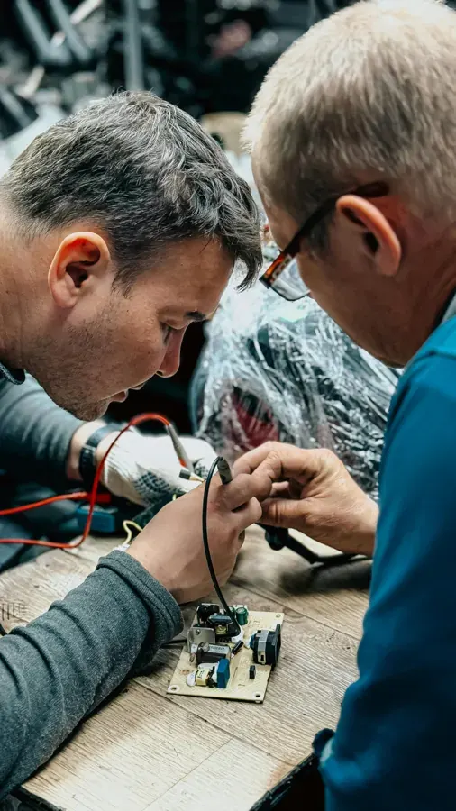 Technicians collaborating on electronics repair for the Jaycar service transformation case study