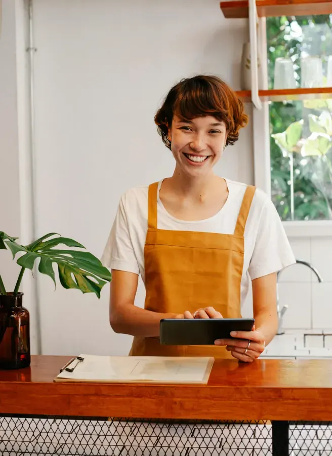 Cheerful employee using a tablet for the mobile sales application case study