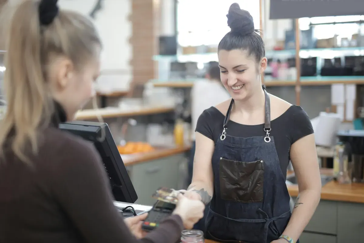 Smiling customer making a secure card payment for the PCI Pal office enablement case study
