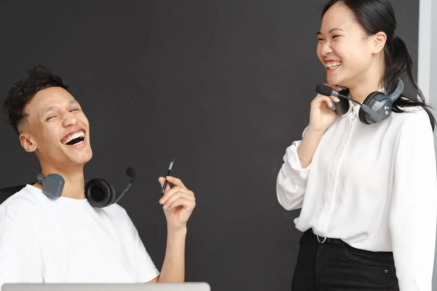 Smiling contact center specializts with headsets representing lower-effort service and reduced cost-to-serve